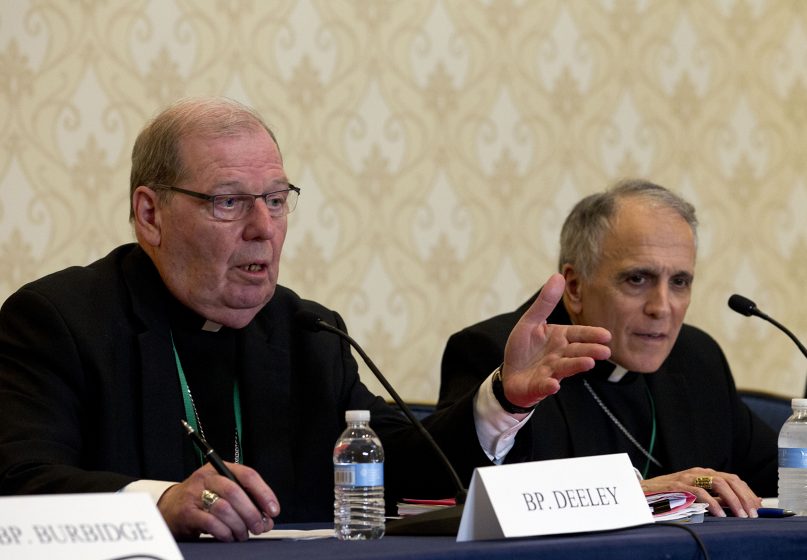Robert Deeley, left, Bishop of the Diocese of Portland, Maine, accompanied by Cardinal Daniel DiNardo, of the Archdiocese of Galveston-Houston and president of the United States Conference of Catholic Bishops, speaks during a news conference at the United States Conference of Catholic Bishops, 2019 spring meetings in Baltimore, Md., Tues., June 11, 2019. (AP Photo/Jose Luis Magana)