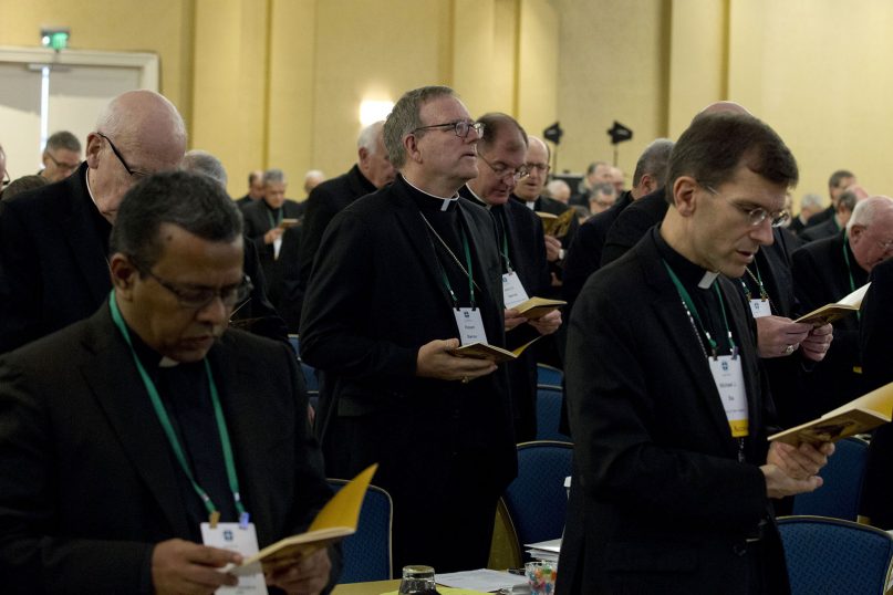 Auxiliary Bishop Robert Barron of Los Angeles, center, along with other bishops, participates in a morning prayer June 11, 2019, during the U.S. Conference of Catholic Bishops' spring 2019 meetings in Baltimore. (AP Photo/Jose Luis Magana)