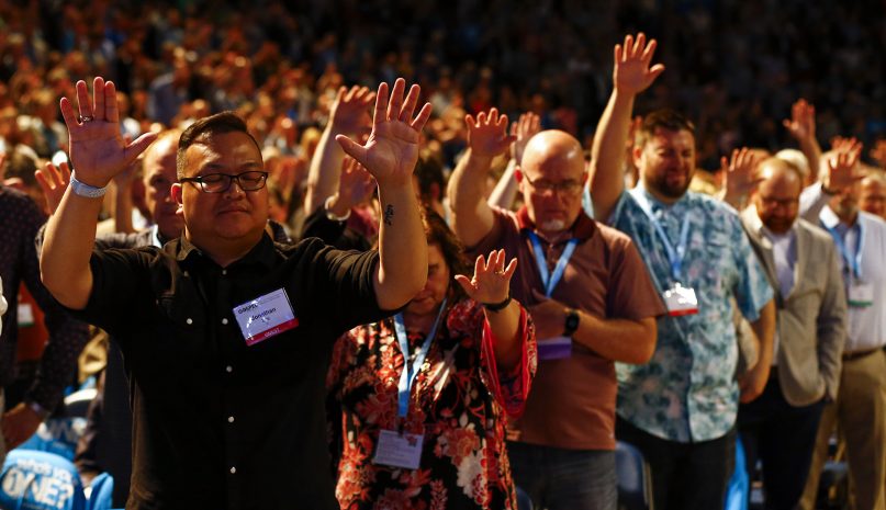 Members of the Southern Baptist Convention and guests lift their hands in prayer during the SBC’s annual meeting in Birmingham, Alabama, on June 11, 2019. 
RNS photo by Butch Dill