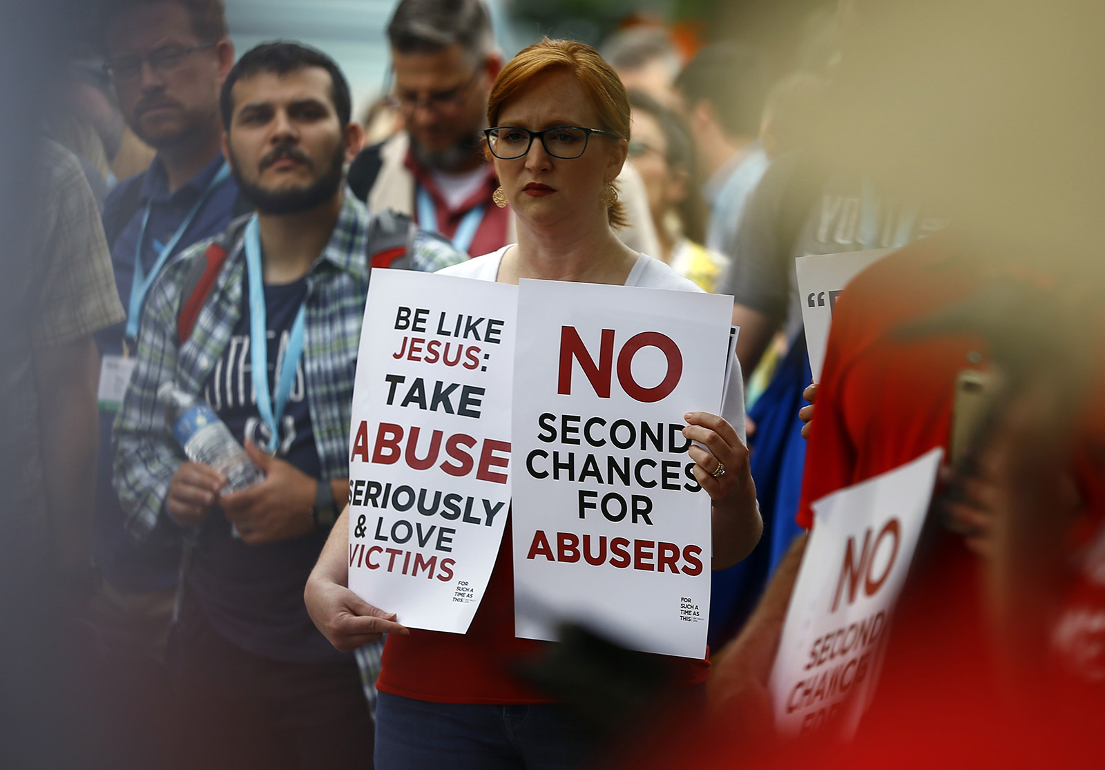 A woman holds signs of abuse during a rally outside the annual meeting of the Southern Baptist Convention at the Birmingham-Jefferson Convention Complex on June 11, 2019 in Birmingham, Ala.  RNS photo of Butch Dill