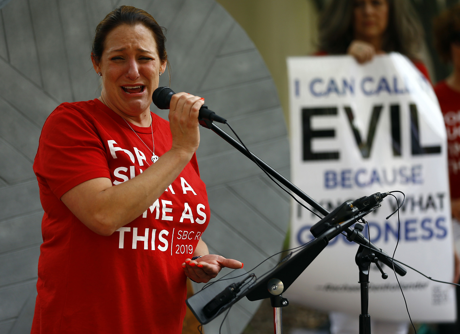 Jules Woodson of Colorado Springs becomes emotional as she talks about her abuse survival during a rally outside the annual meeting of the Southern Baptist Convention at the BJCC, June 11, 2019 in Birmingham, Ala. RNS photo by Butch Dill.