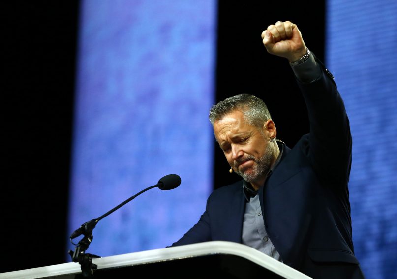 SBC President J.D. Greear  becomes emotional during a lamenting prayer for the sexual abuse that has occurred in the church during the annual meeting of the Southern Baptist Convention on June 12, 2019, in Birmingham, Alabama. RNS photo by Butch Dill.
