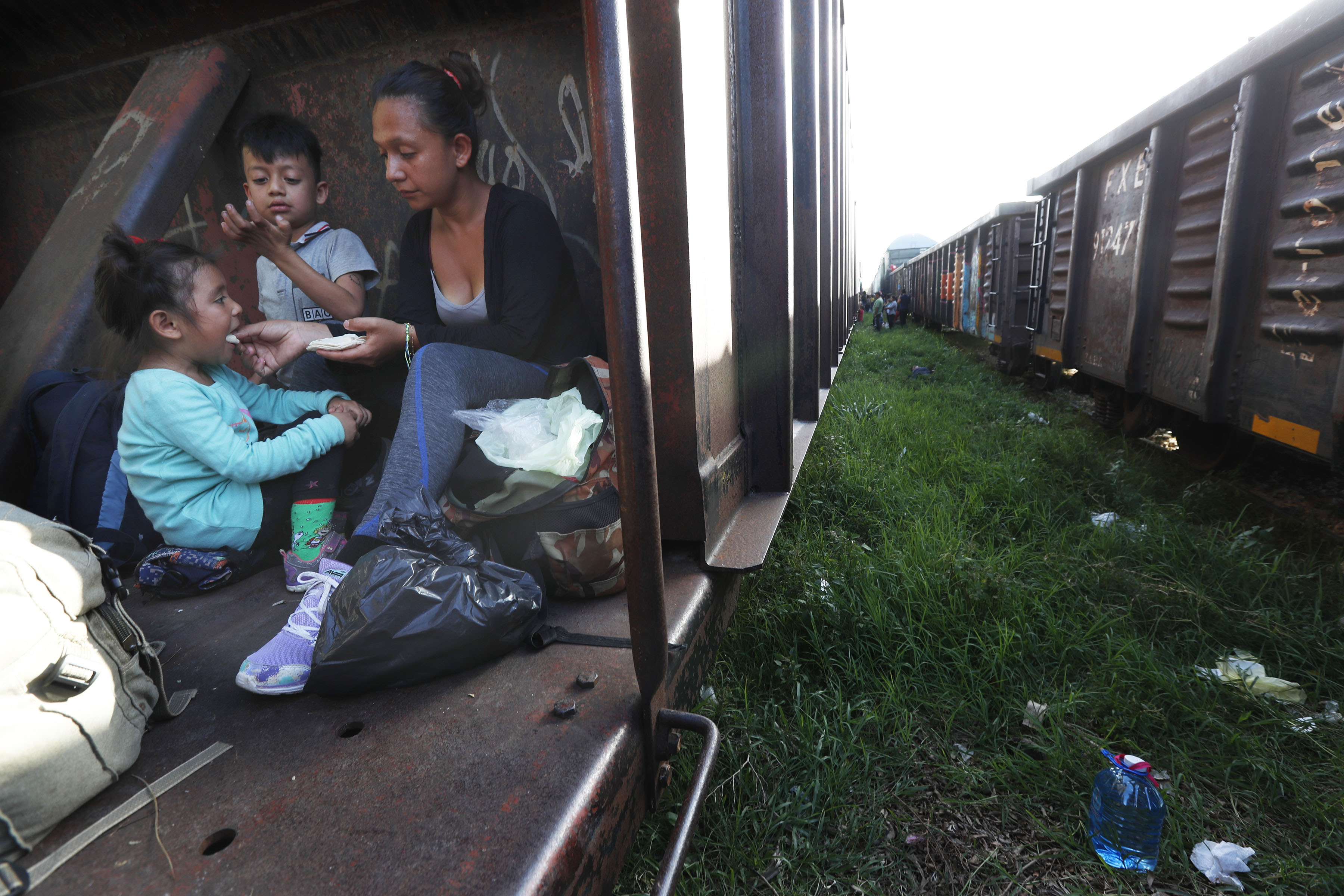 A migrant mother and children ride a freight train on their journey north, in Palenque, Chiapas state, Mexico, on June 24, 2019. The group's next stop will be Coatzacoalcos, Veracruz state. Mexico has deployed 6,500 National Guard members in the southern part of the country, plus another 15,000 soldiers along its northern border in a bid to reduce the number of migrants traveling through its territory to reach the U.S. (AP Photo/Marco Ugarte)