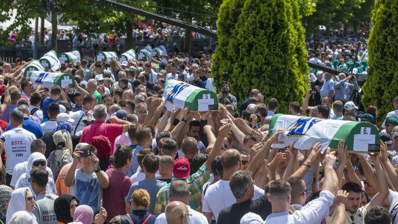 Coffins are carried for the funeral in Potocari near Srebrenica, Bosnia, on July 11, 2019. Thousands of mourners, including relatives of the victims, gathered for a commemoration on the 24th anniversary of the Srebrenica massacre, the worst mass killing in Europe since World War II. The ceremony at a memorial site near Srebrenica included the burial of 33 newly identified victims of the July 11-22, 1995 massacre in which more than 8,000 Bosnian Muslim men and boys were killed in and around the U.N.-protected enclave by Bosnian Serb troops during the Bosnian civil war. (AP Photo/Darko Bandic)