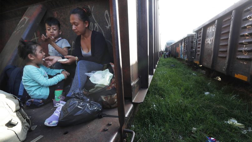 A migrant mother and children ride a freight train on their journey north to seek refuge in the U.S., in Palenque, Chiapas state, Mexico, on June 24, 2019. (AP Photo/Marco Ugarte)