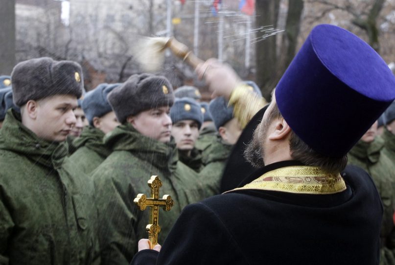 A Russian Orthodox priest blesses military conscripts at a conscription point in downtown Moscow in 2010. Military blessings are common in Russia. (AP Photo/Mikhail Metzel)