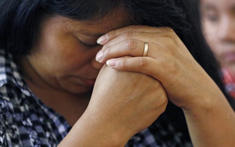 A woman prays during a Spanish Mass at Sacred Heart Catholic Church in Canton, Miss., on Aug. 11, 2019. Churches have been key to providing spiritual and emotional comfort to workers after immigration raids at seven Mississippi poultry plants and are stepping up to provide material aid to jailed or out-of-work church members, even as some church leaders denounce the raids that Republican leaders of the conservative state have applauded. (AP Photo/Rogelio V. Solis)