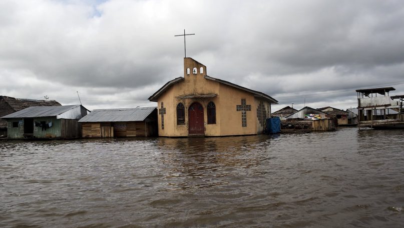 In this April 20, 2015 photo, a Catholic church is surrounded by the rising waters of the Itaya river in Belen, an Amazon community nicknamed “Venice of the Jungle,” in Iquitos, Peru. (AP Photo/Rodrigo Abd)
