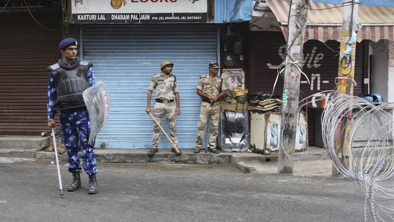 Rapid Action Force (RAF) and paramilitary soldiers stand and guards  during security lockdown in Jammu, India, Friday, Aug.9,2019.(AP Photo/Channi Anand)