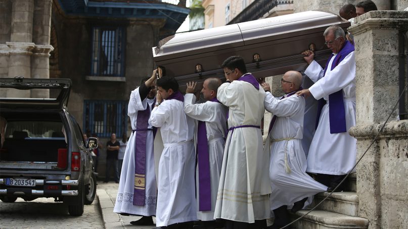 Catholic clergy carry the coffin of late Roman Catholic Cardinal Jaime Lucas Ortega y Alamino to a hearse waiting outside the Cathedral where a final Mass was held in Havana, Cuba, on July 28, 2019. The sugar worker's son who oversaw the first papal visit to Cuba, helped lower barriers to believers in the communist country and played a role in mediating improved U.S.-Cuba ties, died at age 82. (Fernando Medina/Pool photo via AP)