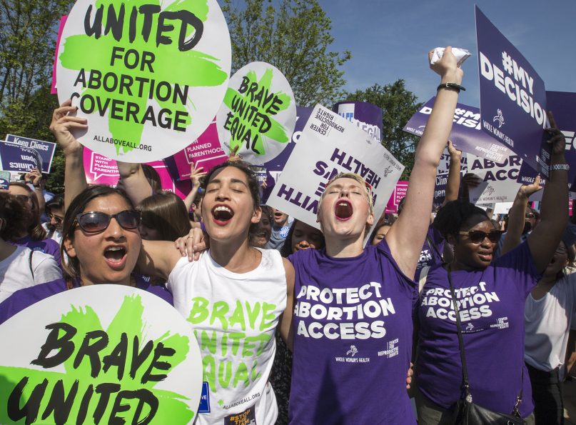 Abortion rights activists rejoice in front of the Supreme Court in Washington after the justices struck down a strict Texas anti-abortion restriction law known as HB2, on June 27, 2016. (AP Photo/J. Scott Applewhite)