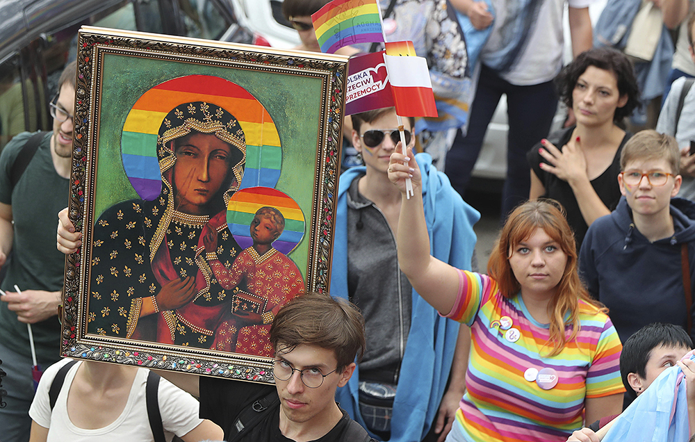 LGBT activists and their supporters gather for the first-ever Pride parade in the central city of Plock, Poland, on Aug. 10, 2019. The parade comes as the country finds itself bitterly divided over the growing visibility of the LGBT community and as the government and powerful Catholic church denounce gay rights as a threat to society. (AP Photo/Czarek Sokolowski)