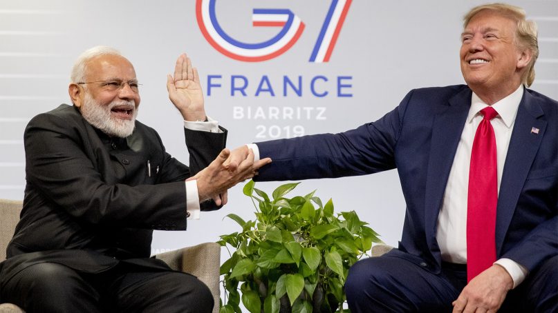 Indian Prime Minister Narendra Modi, left, slaps the hand of President Donald Trump as they share a laugh during a bilateral meeting at the G-7 summit in Biarritz, France, on Aug. 26, 2019. (AP Photo/Andrew Harnik)