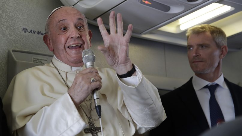 Pope Francis, flanked by his spokesperson Matteo Bruni, addresses journalists during his flight from Antamanarivo to Rome, on Sept. 10, 2019, after his seven-day pastoral trip to Mozambique, Madagascar, and Mauritius. (AP Photo/Alessandra Tarantino)