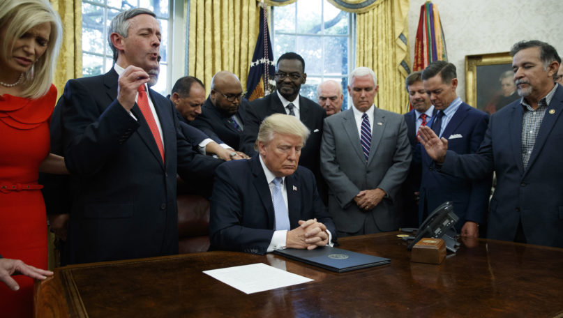 Faith leaders pray with President Donald Trump after he signed a proclamation for a national day of prayer to occur on Sunday, Sept. 3, 2017, in the Oval Office of the White House, Friday, Sept. 1, 2017, in Washington.  (AP Photo/Evan Vucci)