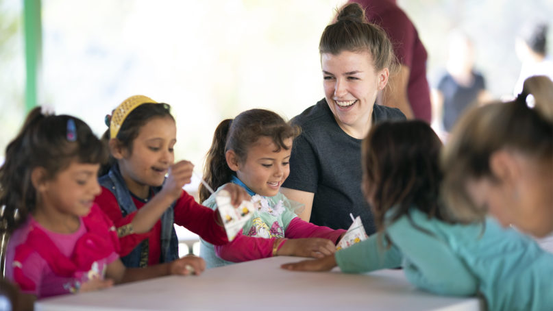 Exodus World Service volunteer Katie Schnizlein, right, interacts with young Syrian refugee girls during a visit to Lebanon in Sept. 2019. Photo by Heidi Zeiger