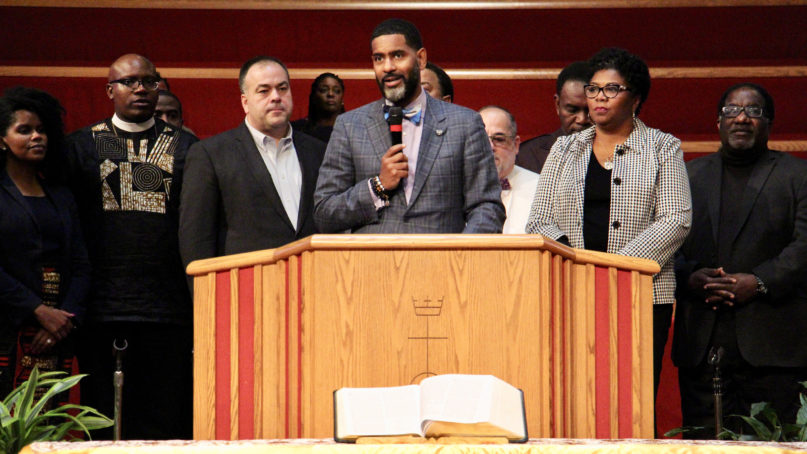 In this RNS file photo from Oct. 20, 2019, the Rev. Otis Moss III, center, joins other leaders of Chicago churches to announce they have purchased and paid off $5.3 million in medical debt for Illinoisans — mostly on Chicago's South Side — through a nonprofit called RIP Medical Debt at a buyout celebration at Trinity United Church of Christ in Chicago. A recent announcement proclaimed that the United Church of Christ has paid off more than $100 million in medical debt since getting involved in the effort. RNS photo by Emily McFarlan Miller