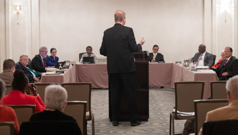 Bishop Kenneth H. Carter, standing, speaks during an oral hearing before the United Methodist Judicial Council meeting in Evanston, Illinois. Photo by Mike DuBose/UMNS