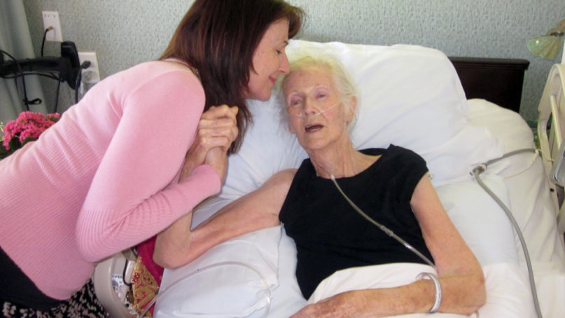 The Rev. Olivia Bareham, left, comforts patient Dorothy Ballon in April 2011, in Los Angeles. Photo courtesy of Sacred Crossings