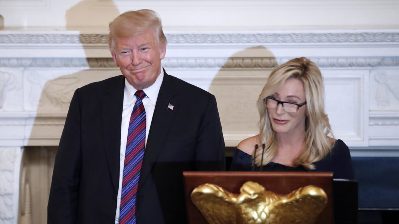 Then-President Donald Trump with pastor Paula White at a dinner for evangelical leaders in the State Dining Room of the White House, Aug. 27, 2018, in Washington. (AP Photo/Alex Brandon)