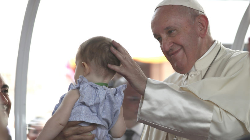 Pope Francis touches the head of a baby at the Saint Louis Hospital in Bangkok, Thailand, Thursday, Nov. 21, 2019. (AP Photo/Rapeephat Sitichailapa)