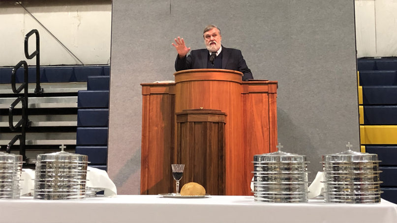 Pastor Douglas Wilson, center, speaks before Communion as Christ Church meets in the Logos School gymnasium on Oct. 13, 2019, in Moscow, Idaho. RNS photo by Tracy Simmons