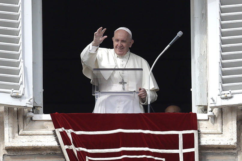 Pope Francis waves during the Angelus noon prayer he delivers from his studio window overlooking St. Peter's Square at the Vatican, Sunday, Nov. 3, 2019. (AP Photo/Gregorio Borgia)