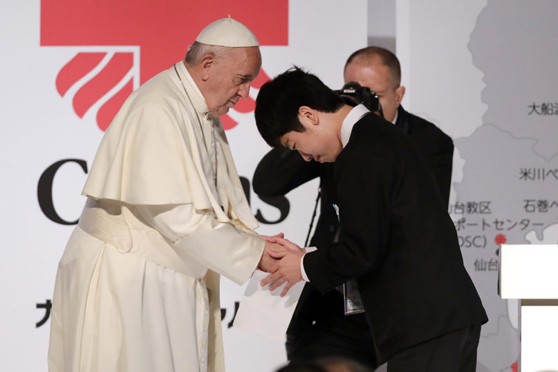 Pope Francis shakes hands with Matsuki Kamoshita as he meets with victims of the March 11, 2011 Fukushima nuclear plant disaster in northern Japan, Monday, Nov. 25, 2019, in Tokyo, Japan. (AP Photo/Jae Hong)