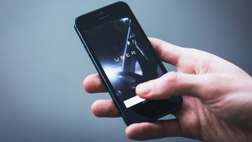 An individual uses the Uber app.  Photo courtesy of freestocks photos/Creative Commons