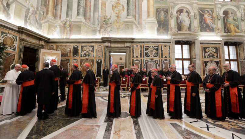 Pope Francis greets cardinals on the occasion of his Christmas greetings to the Roman Curia, in the Clementine Hall at the Vatican, Saturday, Dec. 21, 2019. (AP Photo/Andrew Medichini, Pool)
