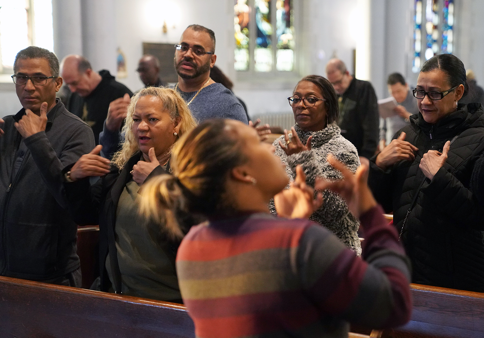 Deaf worshippers sign a hymn while following sign language interpreter Diely Martinez at Holyrood Episcopal Church-Iglesia Santa Cruz in New York City on Dec. 15, 2019. (AP Photo/Emily Leshner)