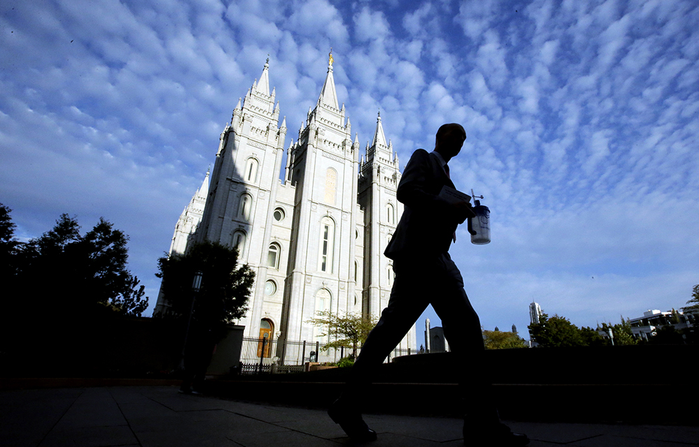 A man walks past the Salt Lake Temple at Temple Square in Salt Lake City on Sept. 14, 2016. (AP Photo/Rick Bowmer)