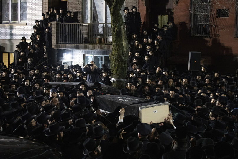 Orthodox Jewish men carry Moshe Deutsch's casket outside a Brooklyn synagogue after his funeral Dec. 11, 2019, in New York. Deutsch was killed Dec. 10 in a shooting inside a Jersey City, New Jersey, kosher food market. (AP Photo/Mark Lennihan)