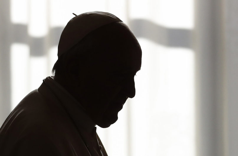 Pope Francis is silhouetted during a private audience at the Vatican on Dec. 14, 2019. (Yara Nardi/Pool photo via AP)