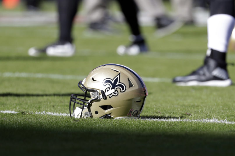 FILE - In this Oct. 23, 2016, file photo, a New Orleans Saints helmet rests on the playing field before an NFL football game in Kansas City, Mo. The Saints are going to court to keep the public from seeing hundreds of emails that allegedly show team executives doing public relations damage control for the area's Roman Catholic archdiocese to help it contain the fallout from a burgeoning sexual abuse crisis. (AP Photo/Jeff Roberson, File)
