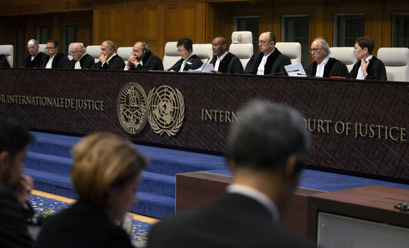 Presiding judge Abdulqawi Ahmed Yusuf, fourth form right, starts reading a ruling at the International Court in The Hague, Netherlands, Thursday, Jan. 23, 2020. The United Nations' top court is scheduled to issue a decision on a request by Gambia to order Myanmar to halt what has been cast as a genocidal campaign against the southeast Asian country's Rohingya Muslim minority. (AP Photo/Peter Dejong)
