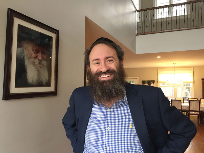Rabbi Zalman Bluming in his Chapel Hill, North Carolina, home beside a photo of Lubavitcher Rabbi Menachem Mendel Schneerson. RNS photo by Yonat Shimron