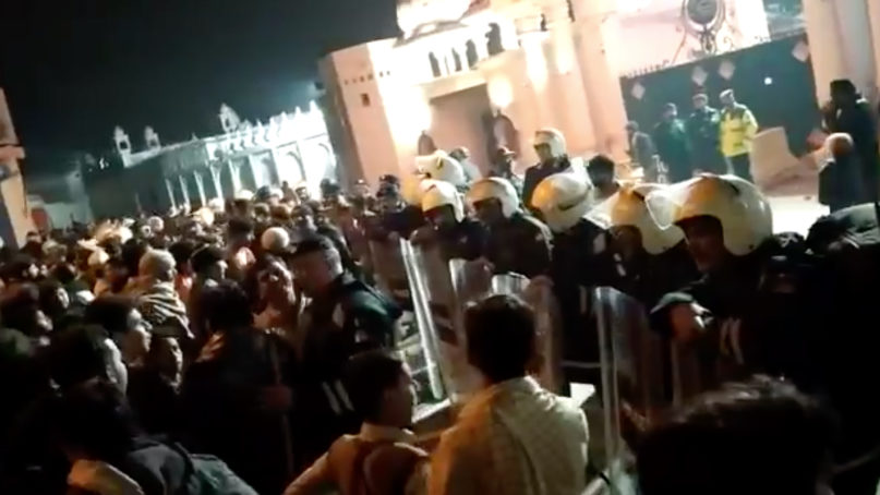 Police try to control a crowd outside the Gurdwara Janam Asthan, a prominent Sikh gurdwara in Nankana Sahib, Pakistan. Video screebgrab via Twitter