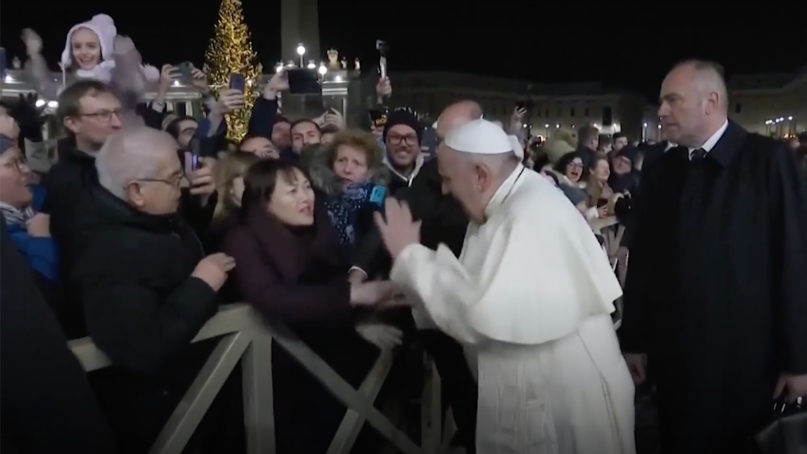 Pope Francis slaps a woman’s hand after she grabbed him near the Nativity scene in St. Peter’s Square on Tuesday, Dec. 31, 2019. Video screengrab via Vatican News