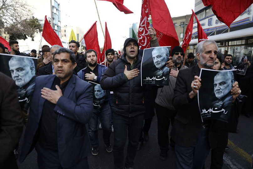 Protesters mourn during a demonstration over the U.S. airstrike in Iraq that killed Iranian Revolutionary Guard Gen. Qassem Soleimani, shown in the posters, in Tehran, Iran, Jan. 3, 2020. Iran has vowed 