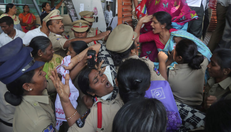 Indian police detains the members of Centre of Indian Trade Unions  (CITU) and other organisations during a protest against U.S. President Donald Trump during his India visit, in Hyderabad, India, Monday, Feb. 24, 2020. (AP Photo/Mahesh Kumar A.)