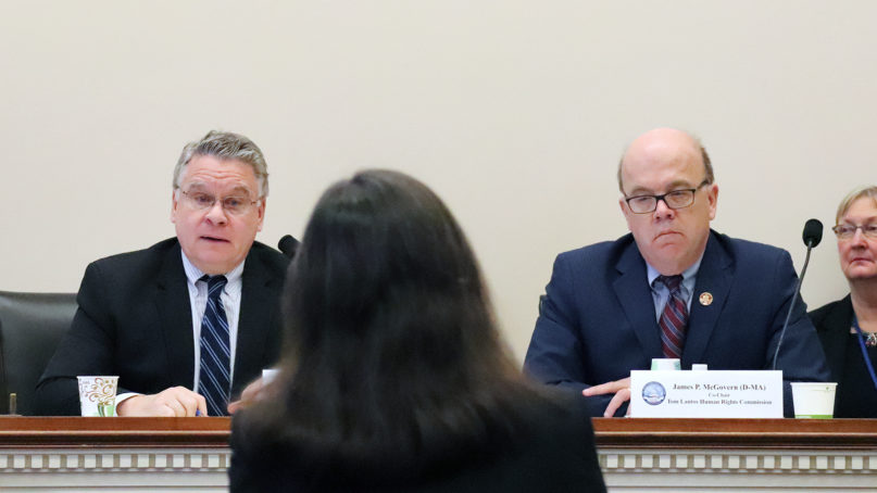 Rep. Chris Smith, R-N.J., left, and Rep. Jim McGovern, D-Mass., right, co-chairs of the Tom Lantos Commission on Human Rights, interact with Elizabeth Cassidy, center, director of research and policy at the U.S. Commission on International Religious Freedom, during a hearing Feb. 27, 2020, at the Rayburn House Office Building in Washington. RNS photo by Adelle M. Banks