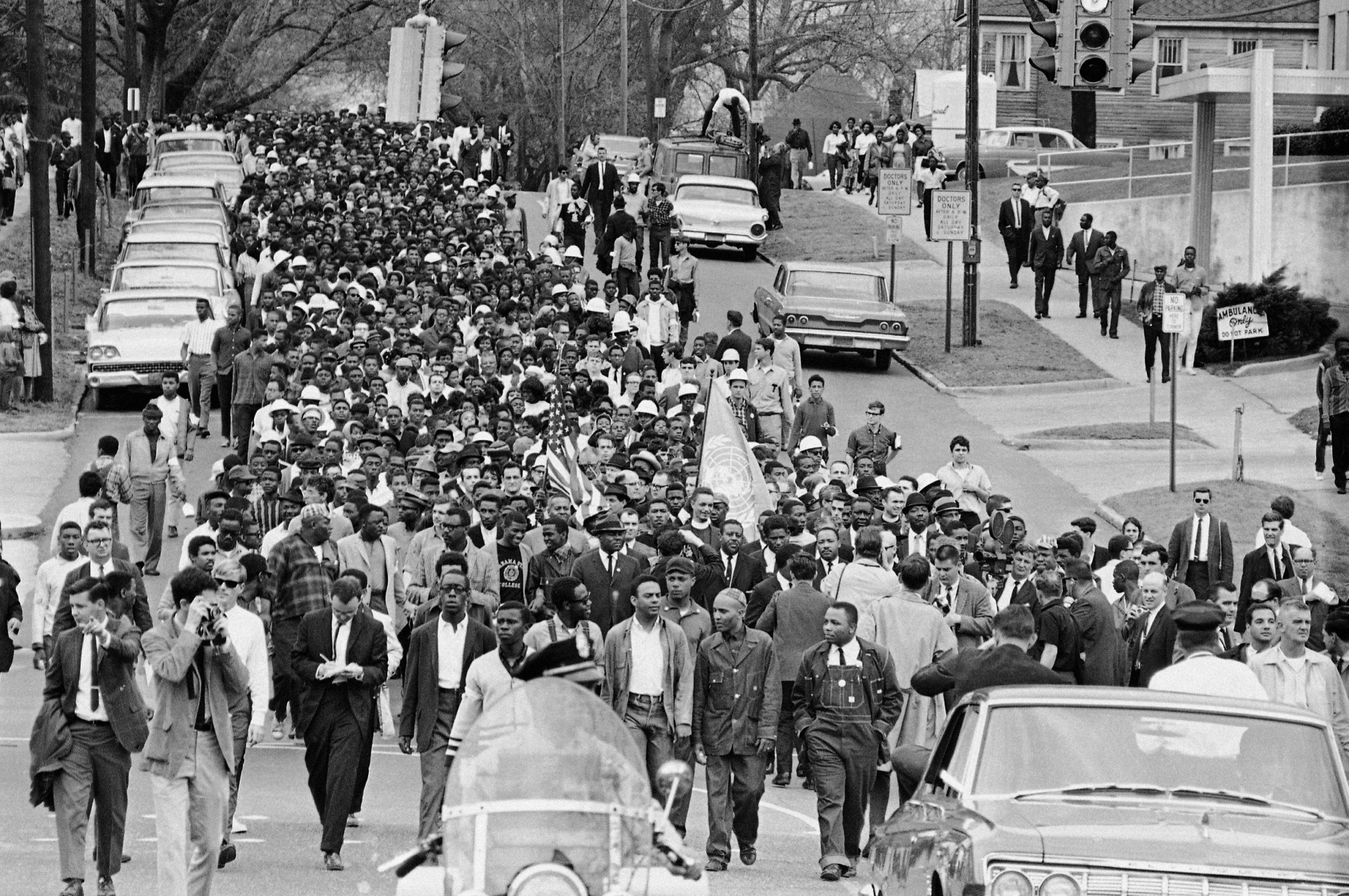 FILE - In this March 17, 1965, file photo, demonstrators walk to the courthouse behind the Rev. Martin Luther King Jr. in Montgomery, Ala. The march was to protest treatment of demonstrators by police during an attempted march. At front and center of march in white shirt is Andrew Young. (AP Photo/File)