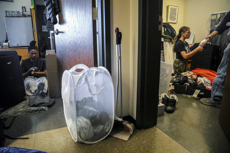 Princeton University students Halima Matthews, 20, left, and best friend Deztynee Rivera, 20, right, pack their rooms to leave after the institution closed campus with plans to continue instruction online due to COVID-19, Saturday, March 14, 2020, in Princeton, N.J. Rivera, a neuroscience junior from Bronx, N.Y., said 