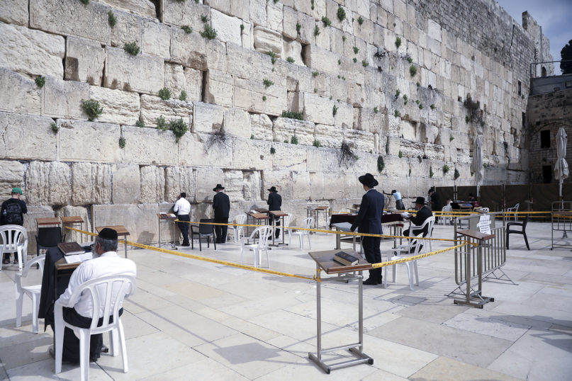 Ultra-Orthodox Jews pray at the Western Wall in Jerusalem on March 15, 2020. Israel imposed sweeping travel and quarantine measures more than a week before, but coronavirus cases have continued to rise. (AP Photo/Mahmoud Illean)