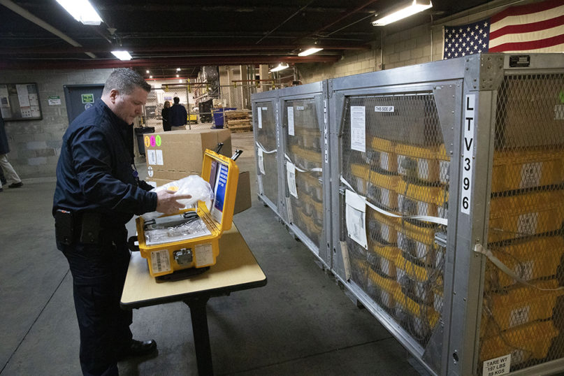 Vincent Dellova, a coordinator at the New York City Emergency Management Warehouse, packs up a ventilator, part of a shipment of 400, that arrived March 24, 2020, in New York. (AP Photo/Mark Lennihan)