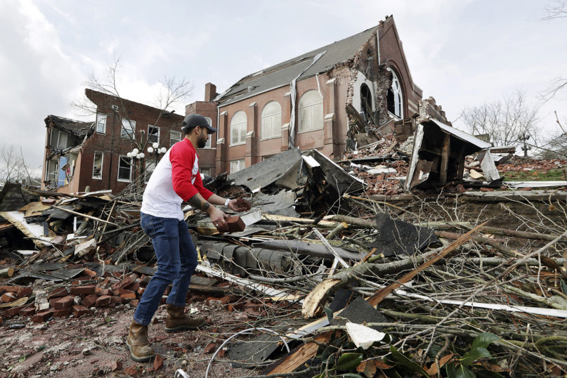 Sumant Joshi helps to clean up rubble at the East End United Methodist Church after it was heavily damaged by storms Tuesday, March 3, 2020, in Nashville, Tenn. Joshi is a resident in the area and volunteered to help clean up. Tornadoes ripped across Tennessee early Tuesday, shredding buildings and killing multiple people. (AP Photo/Mark Humphrey)