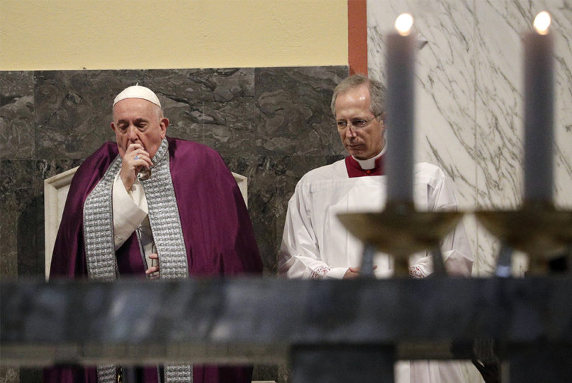 Pope Francis coughs Feb. 26, 2020, inside the Basilica of St. Anselmo in Rome prior to the start of a procession to the Basilica of Santa Sabina before the Ash Wednesday Mass opening Lent, the 40-day period of abstinence and deprivation for Christians before Holy Week and Easter. (AP Photo/Gregorio Borgia)