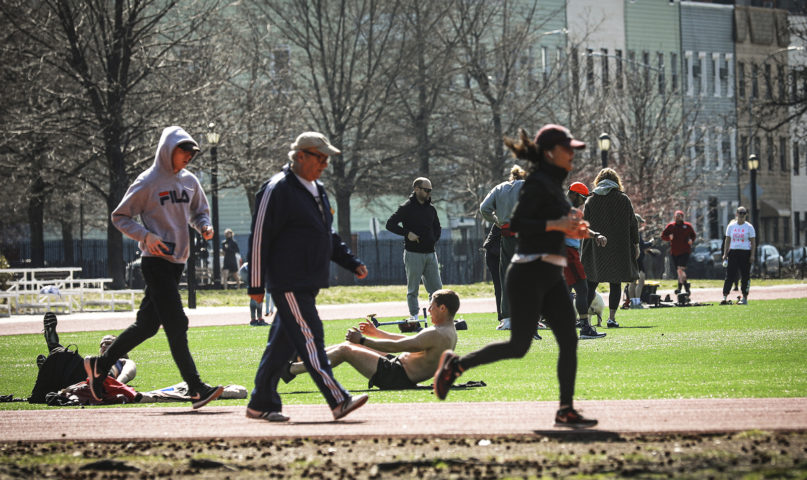 People exercise in McCarren Park in Brooklyn's Williamsburg community, as state and city officials call on residents to practice social distancing amid the COVID-19 outbreak, Wednesday, March 18, 2020, in New York. Governor Andrew Cuomo is urging people to 