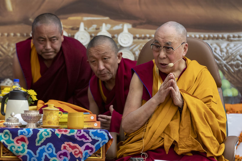 Aides bend to listen to Tibetan spiritual leader the Dalai Lama, right, during an event at the Kirti Monastery in Dharamsala, India, on Dec. 7, 2019. (AP Photo/Ashwini Bhatia)